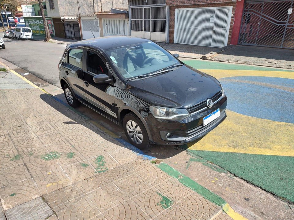 Vista dianteira em três quartos do Volkswagen Gol preto anunciado, estacionado na rua